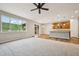 Open-concept living space featuring a modern kitchen, hardwood floors, and a cozy carpeted living area at 17710 E Emilia Dr, Parker, CO 80134