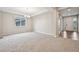 Open living room with a tray ceiling, recessed lighting, large window, and entryway with hardwood floors at 17710 E Emilia Dr, Parker, CO 80134
