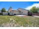 Spacious backyard with a stone patio, green grass and privacy fence at 1933 Chestnut St, Fort Lupton, CO 80621