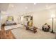 Spacious finished basement with wood flooring, decor, and ample lighting at 1933 Chestnut St, Fort Lupton, CO 80621