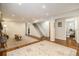 Finished basement with wood flooring, staircase, and adjacent bathroom at 1933 Chestnut St, Fort Lupton, CO 80621