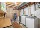 Basement laundry area with washer, dryer, storage, and exposed ceiling at 1933 Chestnut St, Fort Lupton, CO 80621