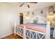 Cozy bedroom features a charming bed frame, ceiling fan, and a convenient walk-in closet at 1933 Chestnut St, Fort Lupton, CO 80621