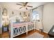 Bright bedroom features a large window with curtains, hardwood floors, and a cozy bed at 1933 Chestnut St, Fort Lupton, CO 80621