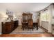 Spacious dining room featuring a large wooden table, antique buffet, and decorative artwork at 1933 Chestnut St, Fort Lupton, CO 80621