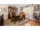 Elegant dining room with ornate wooden furniture, a patterned rug, and bright natural light at 1933 Chestnut St, Fort Lupton, CO 80621