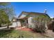 Charming home exterior with a two car garage, lawn, and landscaping at 1933 Chestnut St, Fort Lupton, CO 80621