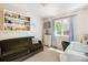 Comfortable office with seating area, desk, shelving, and natural light at 1933 Chestnut St, Fort Lupton, CO 80621
