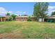 The spacious backyard features an expansive lawn and storage shed at 12063 E Arizona Dr, Aurora, CO 80012