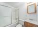 This bathroom features a shower-tub combo, a wood vanity and a framed mirror at 12063 E Arizona Dr, Aurora, CO 80012