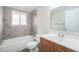 Bathroom featuring a tiled shower and a sink vanity at 12063 E Arizona Dr, Aurora, CO 80012