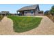 Spacious backyard with a covered patio, well-maintained lawn, and gravel landscaping at 7702 E 157Th Ave, Thornton, CO 80602