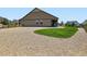 Spacious backyard featuring gravel landscaping, a covered patio, and a lush green lawn at 7702 E 157Th Ave, Thornton, CO 80602