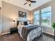Cozy bedroom with neutral walls, large windows, ceiling fan, and a comfortable-looking bed at 7702 E 157Th Ave, Thornton, CO 80602