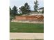 Waterside at Todd Creek community signage surrounded by lush landscaping and greenery at 7702 E 157Th Ave, Thornton, CO 80602