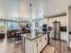 Open-concept kitchen featuring a large island, stainless steel appliances, and modern finishes at 7702 E 157Th Ave, Thornton, CO 80602
