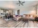 Cozy open-concept living room and kitchen boasts modern finishes and wood-look flooring at 7702 E 157Th Ave, Thornton, CO 80602