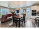 The dining area features a fireplace and plenty of natural light, adjacent to the modern kitchen at 7702 E 157Th Ave, Thornton, CO 80602