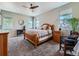 Bright main bedroom featuring carpet floors, multiple windows, and neutral colors at 7702 E 157Th Ave, Thornton, CO 80602