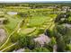 Aerial view of golf course community, showcasing a meticulously landscaped course and surrounding upscale homes at 32 Glenmoor Dr, Englewood, CO 80113