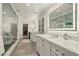 Bright bathroom with double vanity, makeup area and open access to walk-in closet at 32 Glenmoor Dr, Englewood, CO 80113