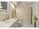 Charming powder room featuring a single vanity with gold fixtures and shower at 32 Glenmoor Dr, Englewood, CO 80113