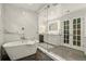 The bathroom features a soaking tub, marble walls, and glass shower enclosure at 32 Glenmoor Dr, Englewood, CO 80113
