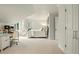 Bright bedroom featuring white walls, carpet and furniture plus a unique pod chair, desk, and ensuite access at 32 Glenmoor Dr, Englewood, CO 80113