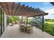 Inviting deck space with a pergola, dining table, and views of the golf course at 32 Glenmoor Dr, Englewood, CO 80113