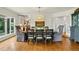 A charming dining room features wood floors, stylish furniture and modern lighting at 32 Glenmoor Dr, Englewood, CO 80113