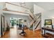 Grand foyer with an open staircase, hardwood floors, and lots of natural light at 32 Glenmoor Dr, Englewood, CO 80113