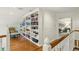 Hallway features hardwood floors, built-in bookshelves, and flows into a bedroom at 32 Glenmoor Dr, Englewood, CO 80113