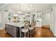 Bright kitchen features an oversized island with marble countertops and seating at 32 Glenmoor Dr, Englewood, CO 80113