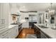 Gourmet kitchen with state-of-the-art stainless steel appliances and custom white cabinetry at 32 Glenmoor Dr, Englewood, CO 80113