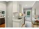Cozy laundry room with ample storage, granite counters, and natural light at 32 Glenmoor Dr, Englewood, CO 80113