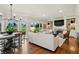 Inviting living room with beautiful golf course views, fireplace, and combined dining area at 32 Glenmoor Dr, Englewood, CO 80113