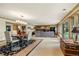 Expansive living area with a dining table, lounge seating, and large windows overlooking the outdoors at 32 Glenmoor Dr, Englewood, CO 80113