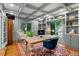 Charming office features a comfortable chair, large windows, and custom cabinets at 32 Glenmoor Dr, Englewood, CO 80113