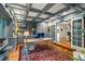 Comfortable office features custom cabinets, coffered ceilings, and a decorative rug over the hardwood floors at 32 Glenmoor Dr, Englewood, CO 80113