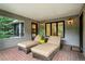 Relaxing covered patio with daybeds and lovely green views at 32 Glenmoor Dr, Englewood, CO 80113