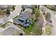 Aerial view showcasing a home with a well-manicured backyard, patio, and outdoor seating area surrounded by lush greenery at 7106 Cerney Cir, Castle Pines, CO 80108