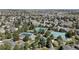 Aerial view showcasing community amenities including a pool, tennis courts, and green spaces nestled among residential homes at 7106 Cerney Cir, Castle Pines, CO 80108