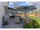 Inviting backyard patio with stone surround, seating, and umbrellas, perfect for outdoor gatherings and relaxation at 7106 Cerney Cir, Castle Pines, CO 80108