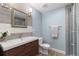 Tastefully updated bathroom with a modern vanity, stylish mirror, and a glass-enclosed shower at 7106 Cerney Cir, Castle Pines, CO 80108