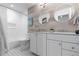 Bright bathroom with double sinks, decorative mirrors, and a shower-tub combination at 7106 Cerney Cir, Castle Pines, CO 80108