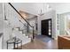 Elegant foyer with hardwood floors, staircase, a chandelier, and a stylish black front door at 7106 Cerney Cir, Castle Pines, CO 80108