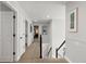 Bright hallway featuring neutral walls, plush carpet, and access to various rooms in the home at 7106 Cerney Cir, Castle Pines, CO 80108