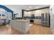 Well-equipped kitchen with modern stainless appliances, a kitchen island, and ample cabinet space for storage at 7106 Cerney Cir, Castle Pines, CO 80108