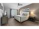Comfortable main bedroom featuring a ceiling fan, bedside tables, and natural light at 7106 Cerney Cir, Castle Pines, CO 80108