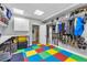 Spacious mudroom with playful flooring, built-in storage, and easy access to the garage at 7106 Cerney Cir, Castle Pines, CO 80108